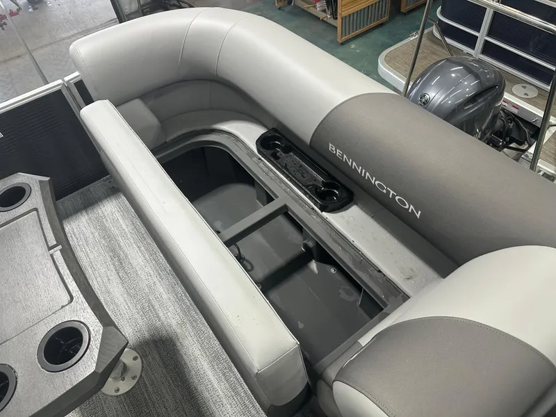 Slide: The Image of 2025 Bennington 22SSRSE pontoon boat interior with seating and storage compartment. - 17