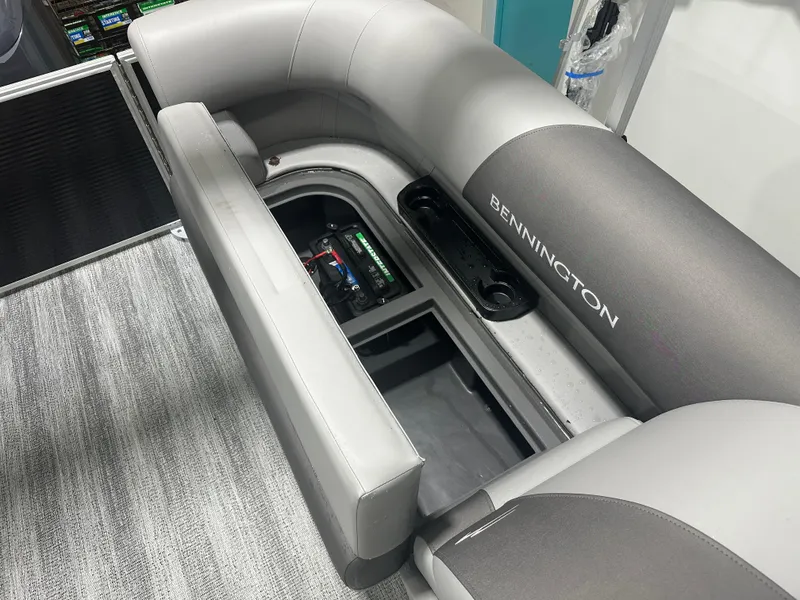 Slide: The Image of 2025 Bennington 22SSRSE boat interior with open storage compartment and battery. - 22
