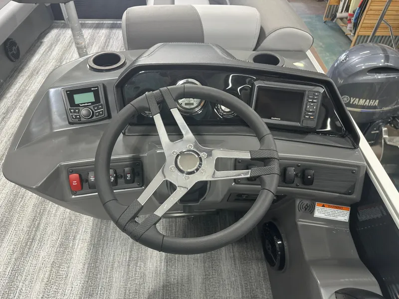 Slide: The Image of 2025 Bennington 22SSRSE boat dashboard with steering wheel and control panel. - 25