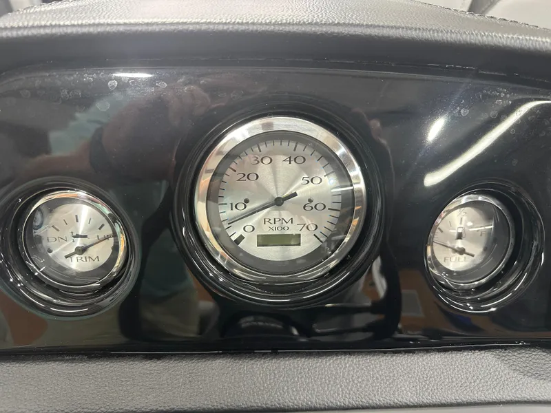 Slide: The Image of Dashboard gauges of 2025 Bennington 22SSRSE boat, showing RPM, trim, and fuel levels. - 28