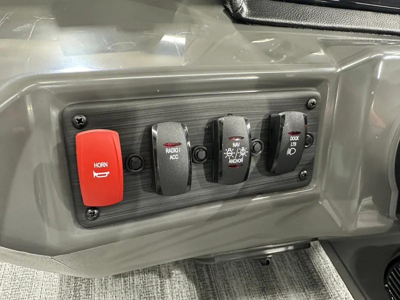 Slide: The Image of Control panel of 2025 Bennington 22SSRSE boat with horn, radio, navigation, and dock light switches. - 29