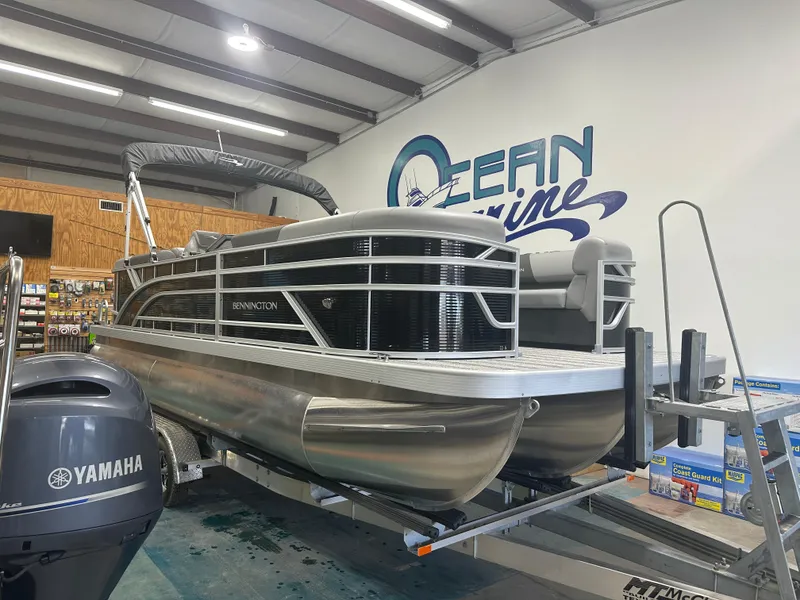 Slide: The Image of 2025 Bennington 22SSRSE pontoon boat in showroom with Yamaha motor. - 3