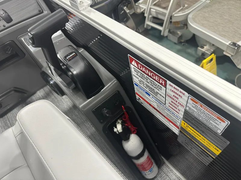 Slide: The Image of 2025 Bennington 22SSRSE boat control panel with safety warnings and fire extinguisher. - 31