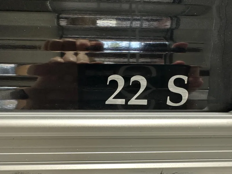Slide: The Image of Close-up of 2025 Bennington 22SSRSE boat model number "22 S" on metallic surface. - 32