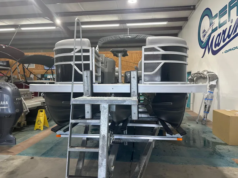 Slide: The Image of 2025 Bennington 22SSRSE pontoon boat in a showroom, rear view. - 5