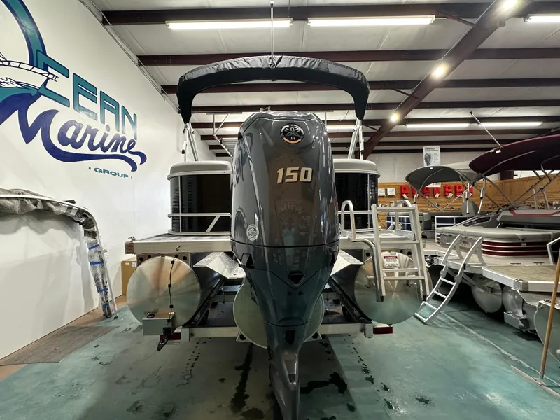 Slide: The Image of 2025 Bennington 22SSRSE pontoon boat with 150 HP engine in showroom. - 7