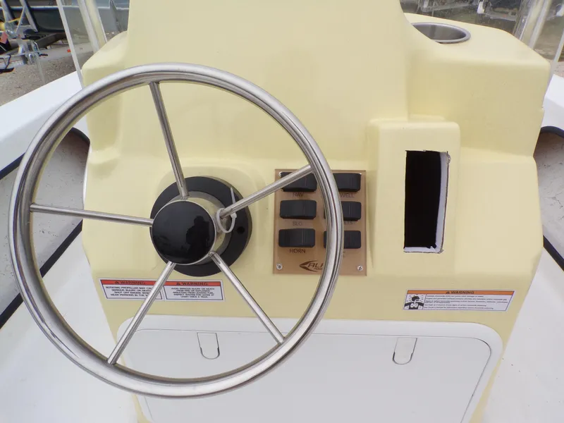 Slide: The Image of Steering console of 2024 k2 Powerboats 17HS with control panel and wheel. - 10