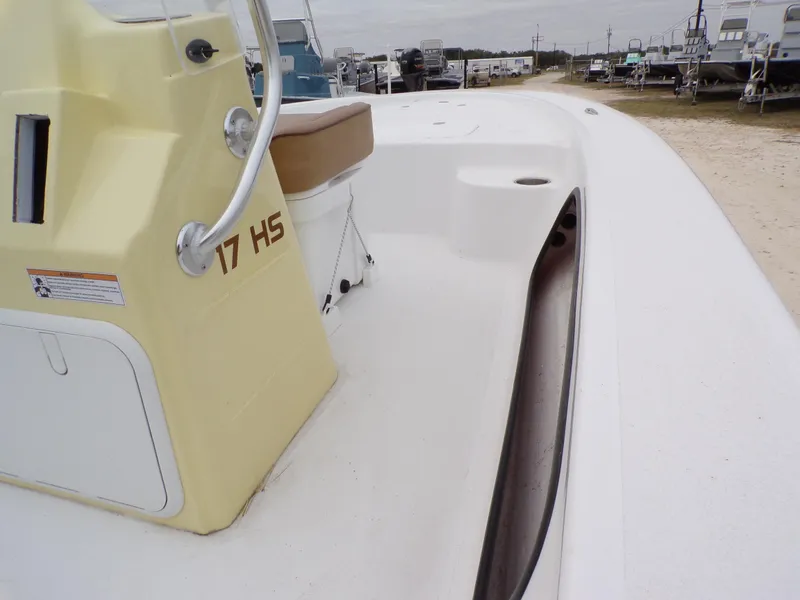 Slide: The Image of 2024 K2 Powerboats 17HS, yellow console, white deck, parked outdoors. - 11