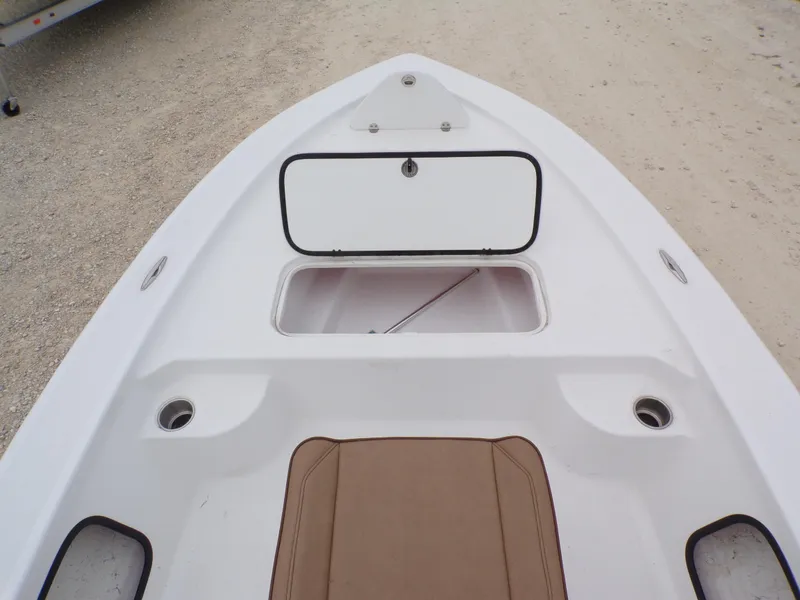 Slide: The Image of 2024 k2 Powerboats 17HS bow with open storage compartment, white deck, and brown seating. - 12
