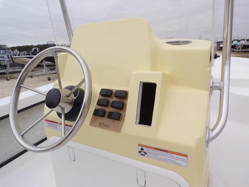 Slide: The Image of 2024 k2 Powerboats 17HS console with steering wheel and control panel. - 9