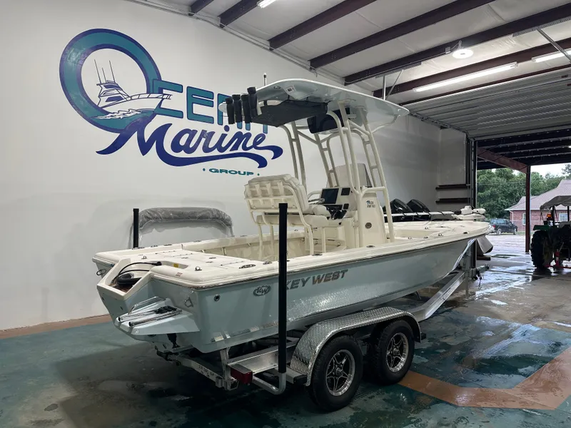 Slide: The Image of 2025 Key West 230BR boat on trailer inside Ocean Marine Group facility. - 11