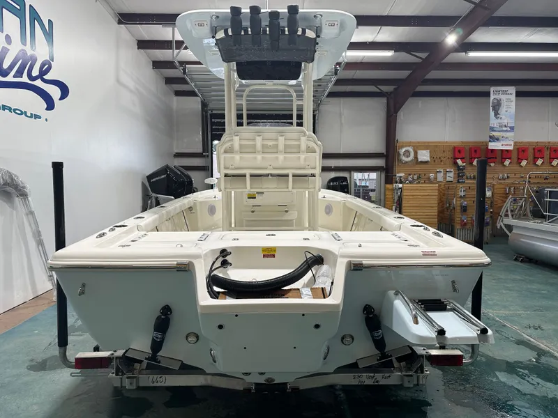 Slide: The Image of 2025 Key West 230BR boat in showroom, rear view, showcasing deck and equipment. - 12