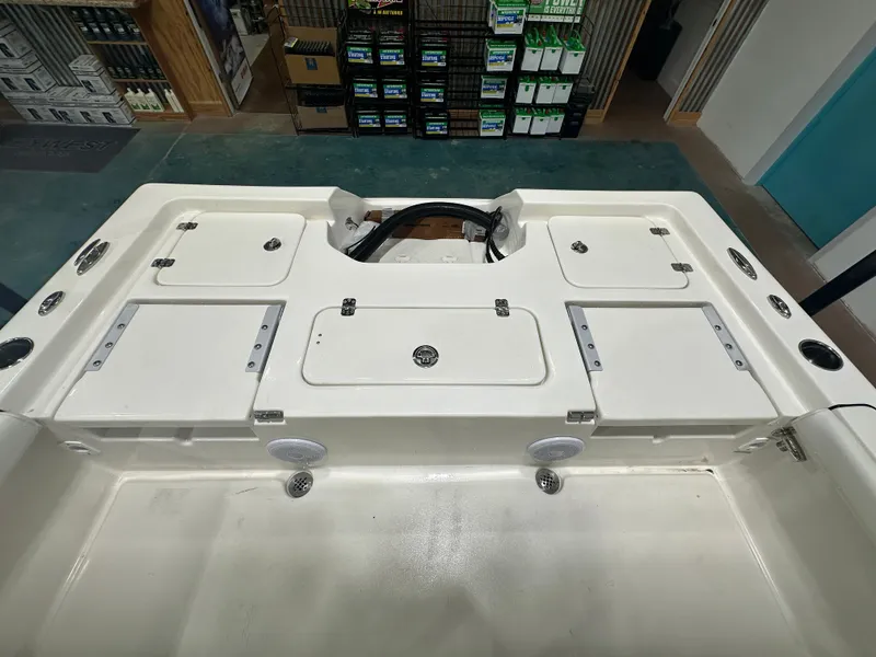 Slide: The Image of 2025 Key West 230BR boat interior with storage compartments and cup holders. - 21