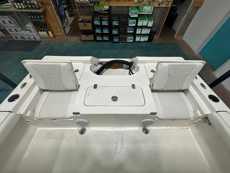 Slide: The Image of 2025 Key West 230BR boat interior with white seating and storage compartments. - 22