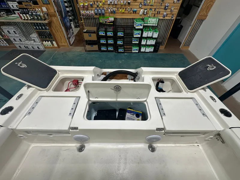 Slide: The Image of 2025 Key West 230BR boat interior with open storage compartments and visible equipment. - 23