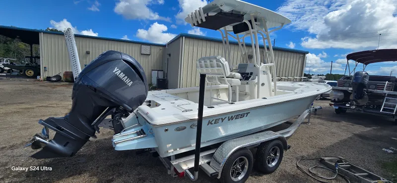 Slide: The Image of 2025 Key West 230BR boat with Yamaha engine on a trailer, parked outdoors. - 3