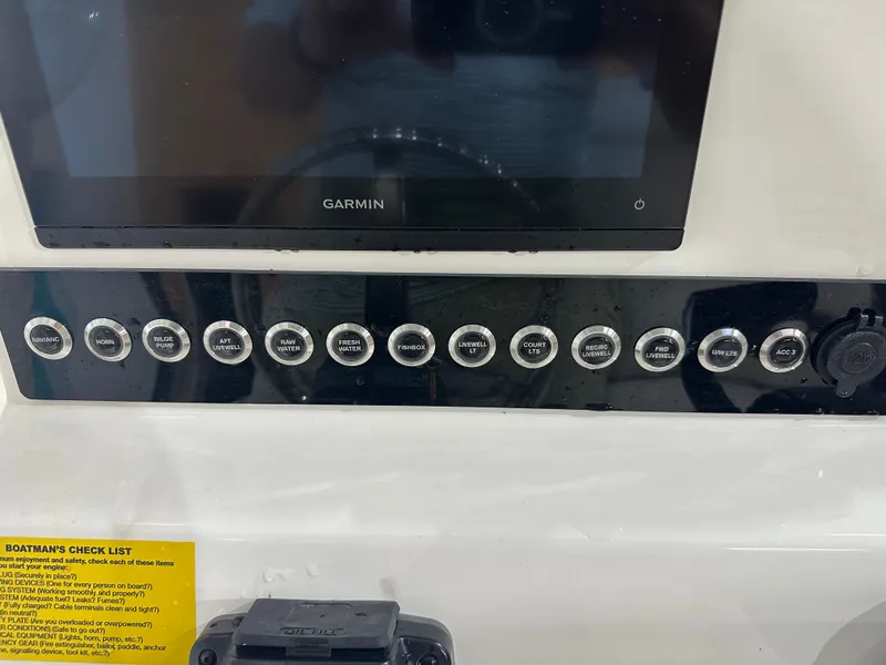 Slide: The Image of Control panel of 2025 Key West 230BR boat with Garmin display and various switches. - 32