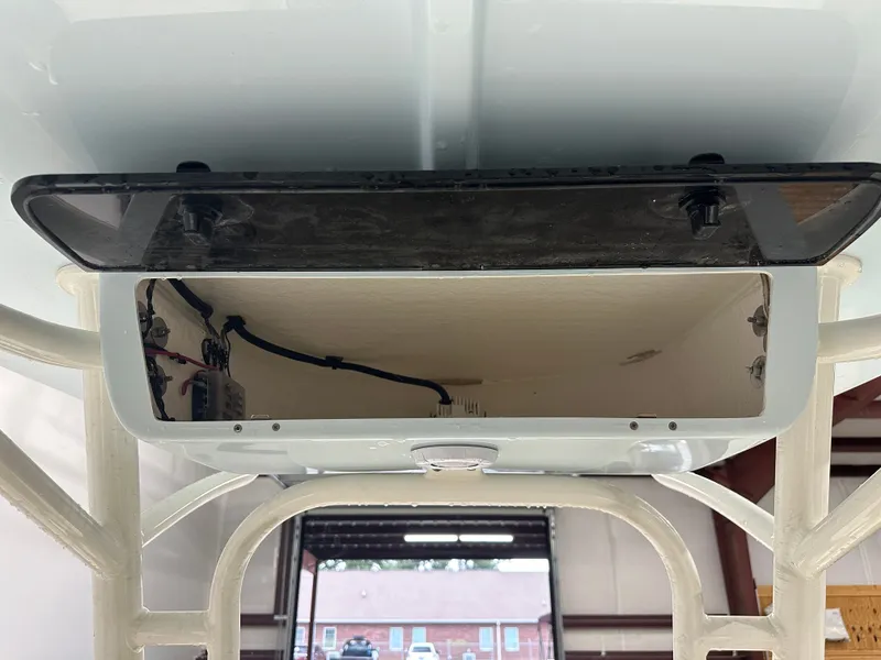 Slide: The Image of 2025 Key West 230BR boat compartment with wiring and open hatch. - 34