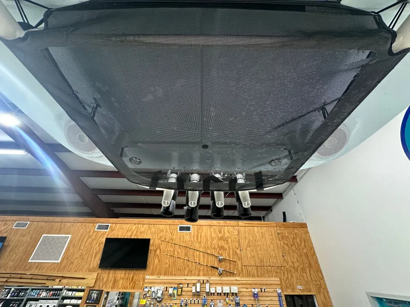 Slide: The Image of Ceiling view of a 2025 Key West 230BR boat with rod holders and speakers. - 35