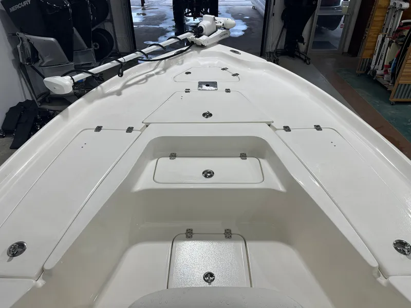 Slide: The Image of 2025 Key West 230BR boat interior with storage compartments and trolling motor. - 36