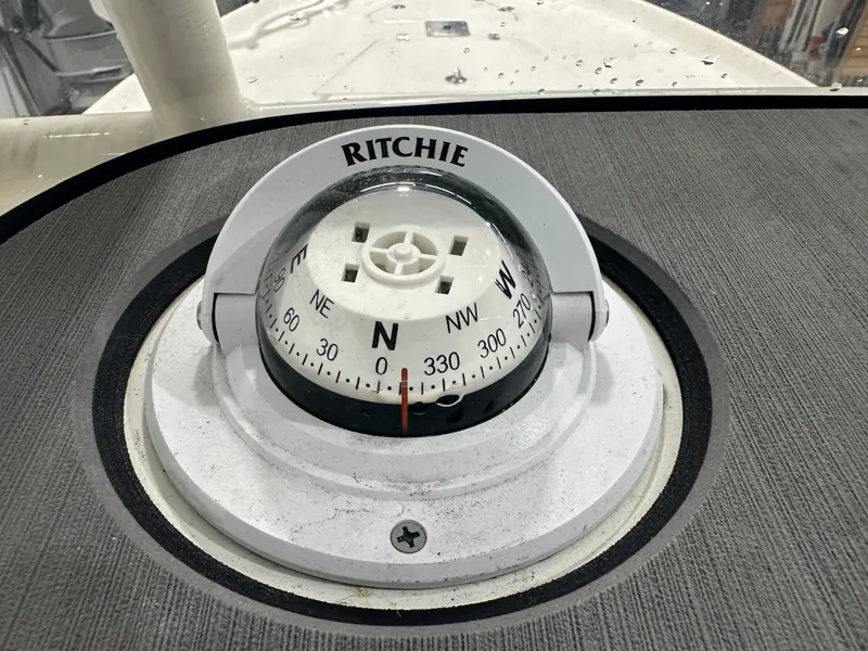 Slide: The Image of Ritchie compass on 2025 Key West 230BR boat dashboard, showing north direction. - 37