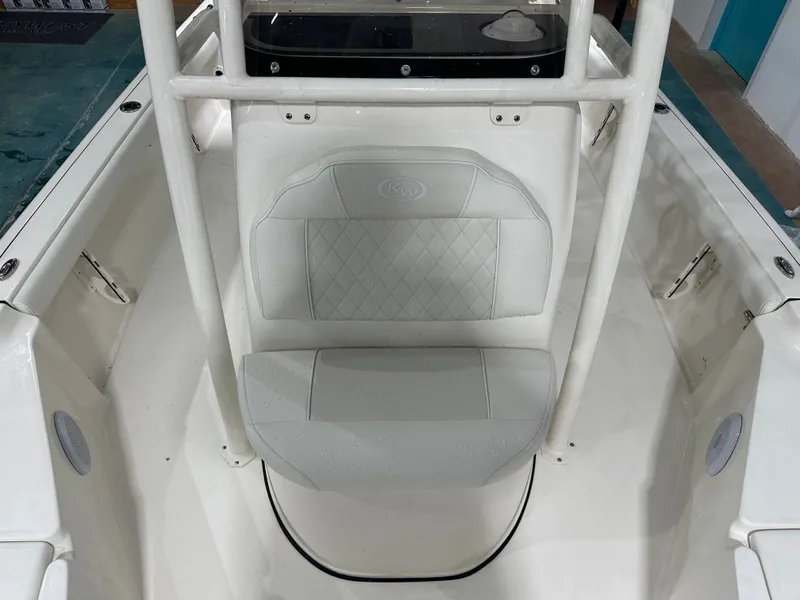 Slide: The Image of 2025 Key West 230BR boat interior with cushioned seating and white framework. - 39
