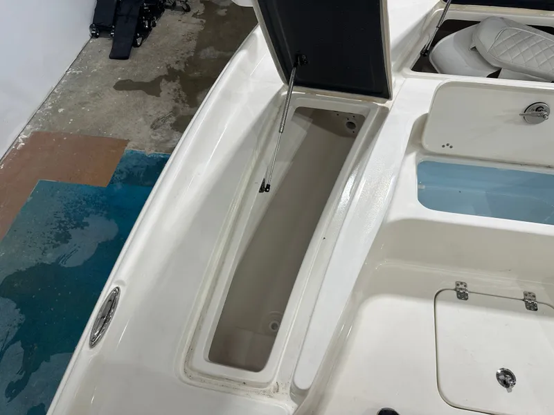 Slide: The Image of 2025 Key West 230BR boat storage compartment with open hatch, showcasing interior space. - 46