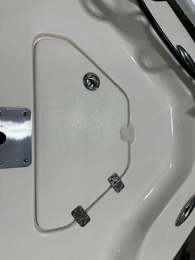 Slide: The Image of 2025 Key West 230BR boat hatch with metal hinges and latch. - 48