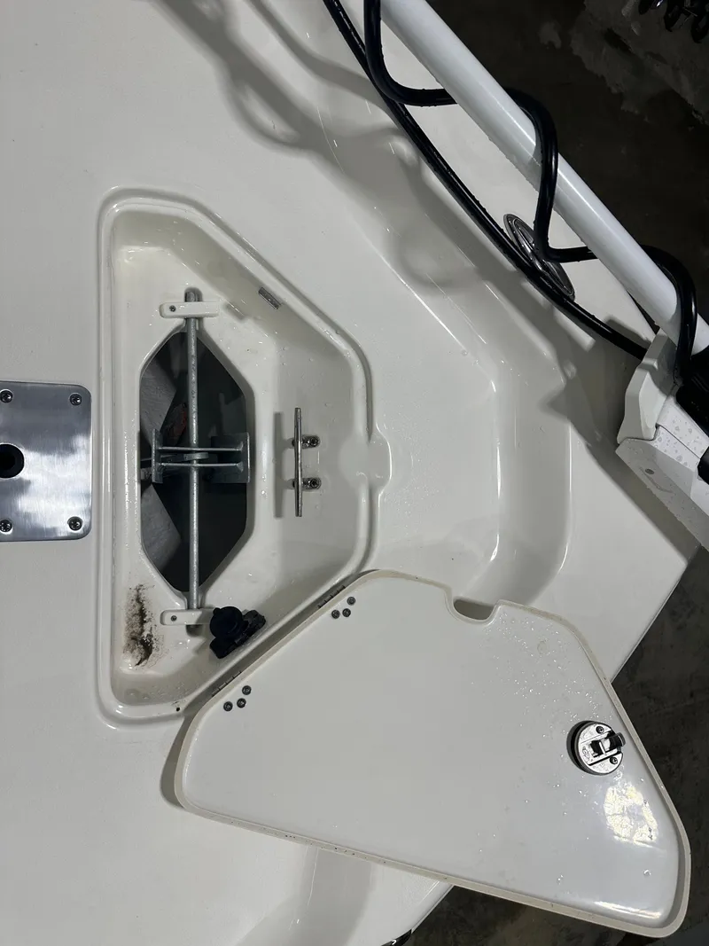 Slide: The Image of Open anchor compartment on 2025 Key West 230BR boat, showing anchor storage and hardware. - 49