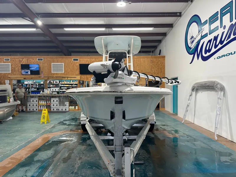Slide: The Image of 2025 Key West 230BR boat displayed in a showroom with marine equipment. - 6