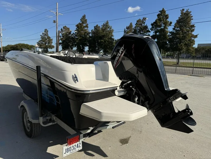 Slide: The Image of 2022 Bayliner Element E18 boat with Mercury outboard motor on trailer. - 10