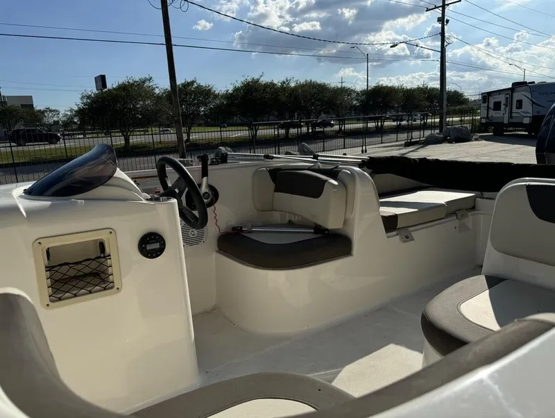 Slide: The Image of 2022 Bayliner Element E18 boat interior with seating and steering wheel. - 13