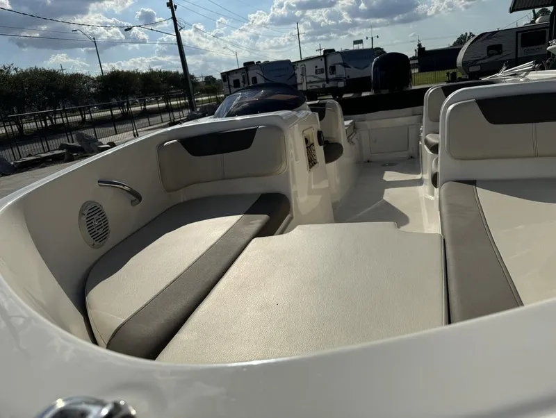 Slide: The Image of 2022 Bayliner Element E18 boat interior with cushioned seating under a sunny sky. - 4