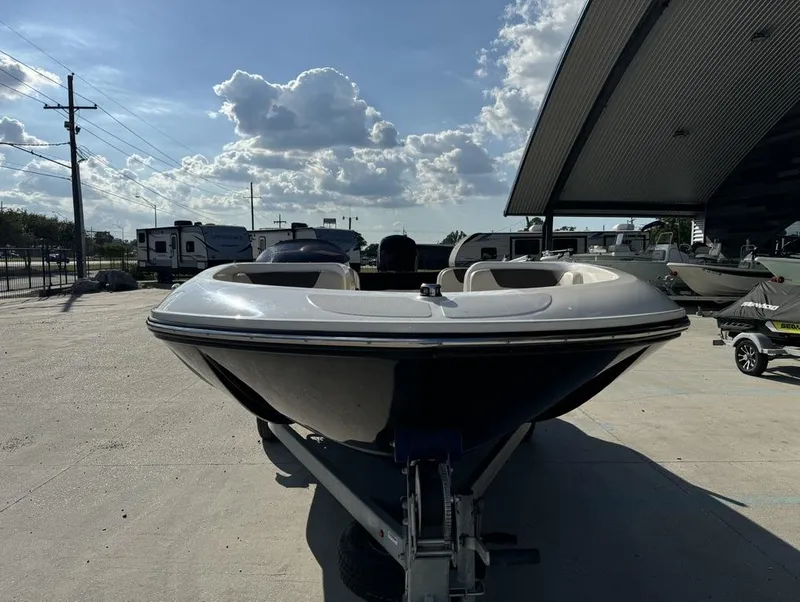 Slide: The Image of 2022 Bayliner Element E18 boat on trailer under cloudy sky. - 6
