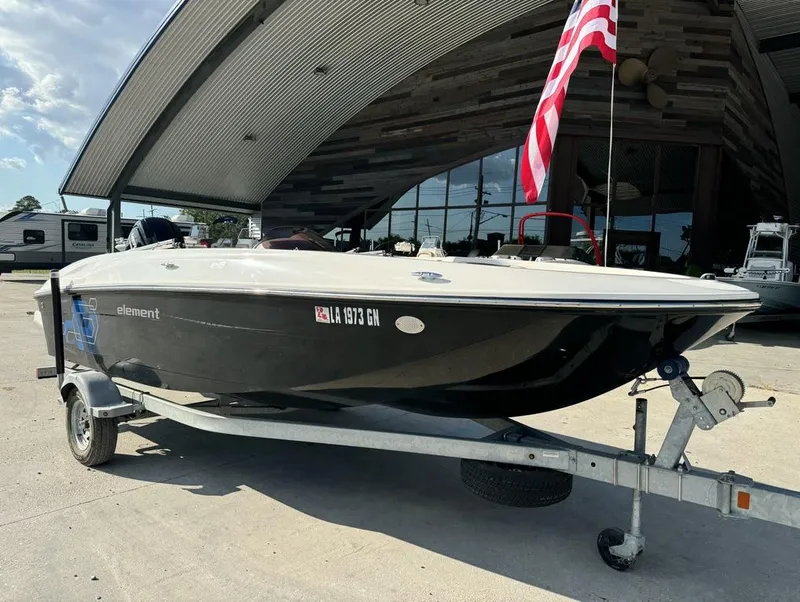 Slide: The Image of 2022 Bayliner Element E18 boat on trailer with American flag in background. - 7