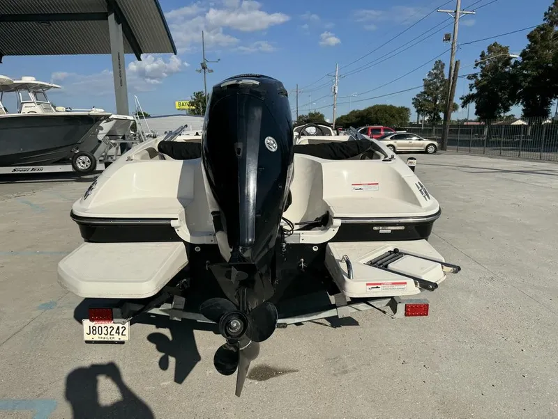 Slide: The Image of 2022 Bayliner Element E18 boat with outboard motor, parked on concrete lot. - 9