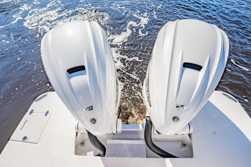Slide: The Image of 2022 Regal 36 XO boat with dual outboard engines on water. - 13