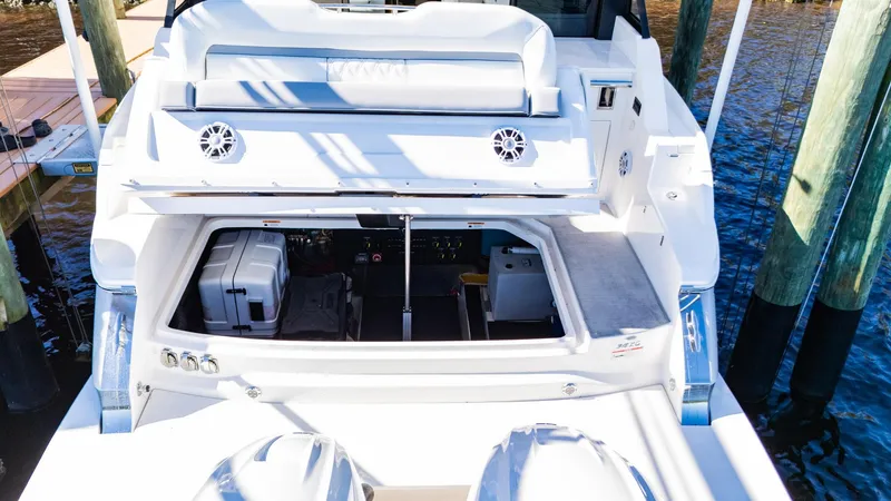 Slide: The Image of 2022 Regal 36 XO boat with open storage compartment at dock. - 15