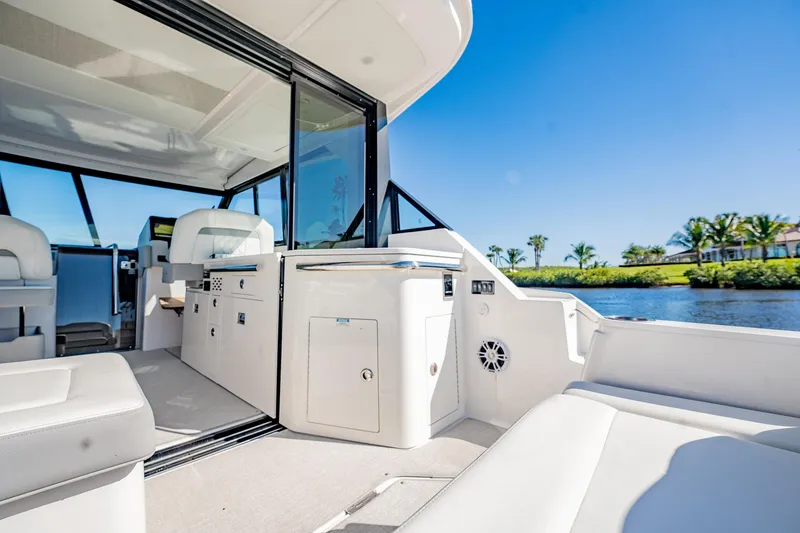Slide: The Image of 2022 Regal 36 XO boat interior with sleek design and waterfront view. - 17
