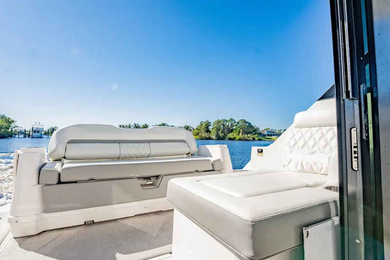 Slide: The Image of Luxurious 2022 Regal 36 XO boat interior with plush seating and scenic water view. - 19