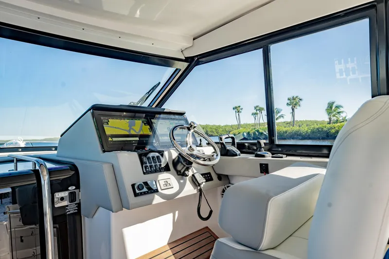 Slide: The Image of Interior of 2022 Regal 36 XO yacht with modern helm and panoramic windows. - 26