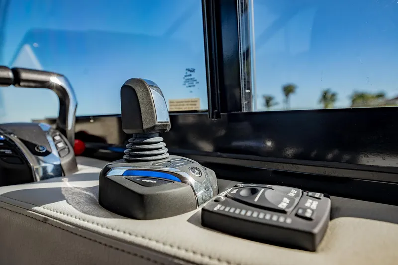 Slide: The Image of Close-up of 2022 Regal 36 XO boat controls with joystick and panel. - 31