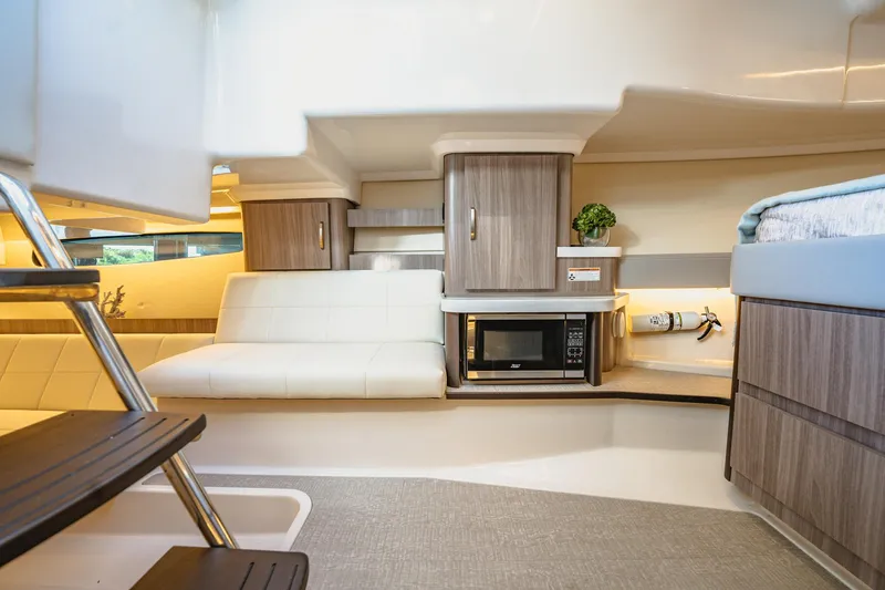 Slide: The Image of Interior of 2022 Regal 36 XO yacht with modern seating and kitchenette. - 37