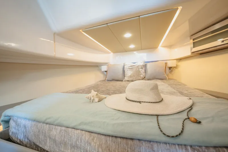 Slide: The Image of Luxurious cabin interior of 2022 Regal 36 XO yacht with cozy bedding and stylish decor. - 39