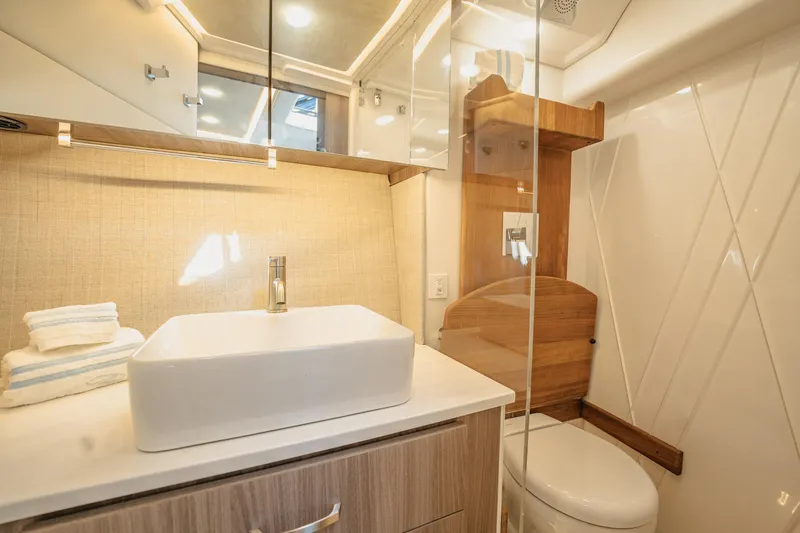 Slide: The Image of Luxurious bathroom in 2022 Regal 36 XO yacht with modern sink and toilet. - 43