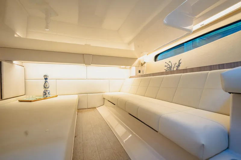 Slide: The Image of Luxurious interior of 2022 Regal 36 XO yacht with white seating and ambient lighting. - 44