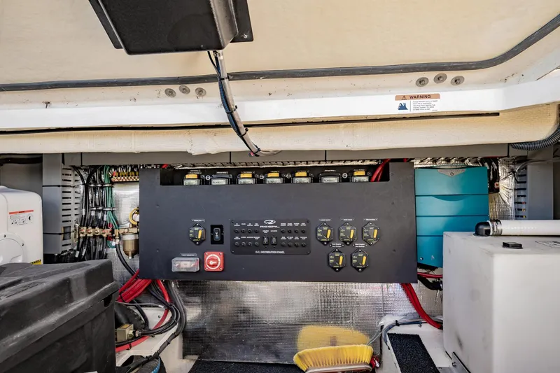 Slide: The Image of Engine room of 2022 Regal 36 XO boat, featuring control panel and wiring. - 47