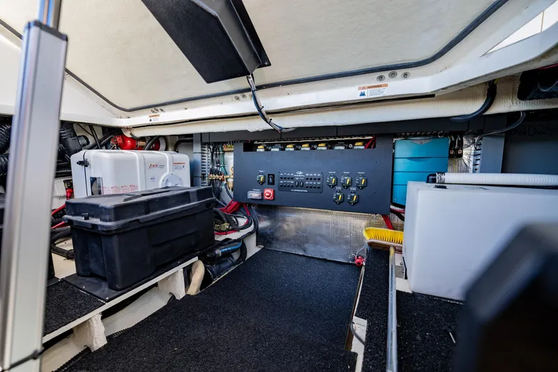 Slide: The Image of Engine room of 2022 Regal 36 XO boat with control panel and storage. - 50