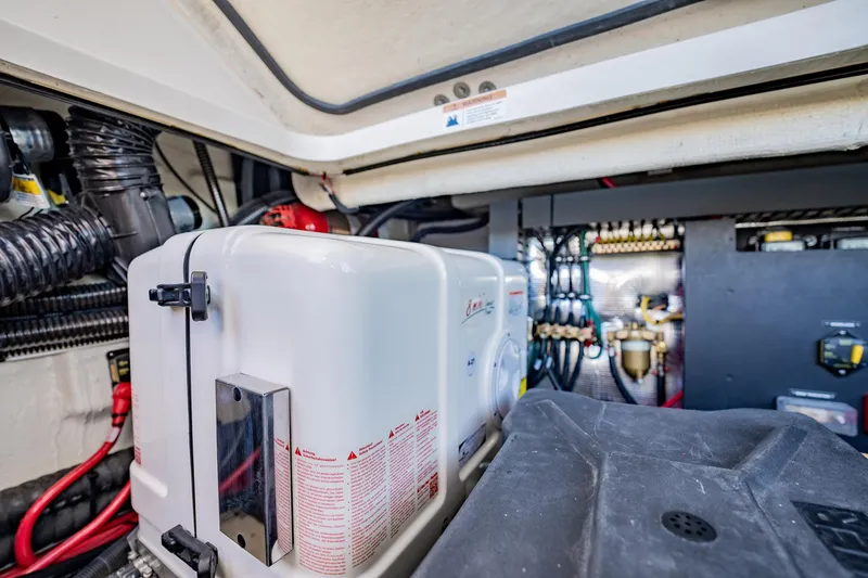 Slide: The Image of Engine room of 2022 Regal 36 XO boat, showcasing generator and wiring. - 51