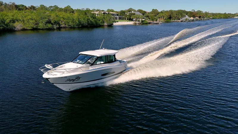 Slide: The Image of 2022 Regal 36 XO cruising on a scenic river. - 58